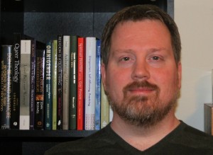 That's me... standing in front of some books on queer theology...